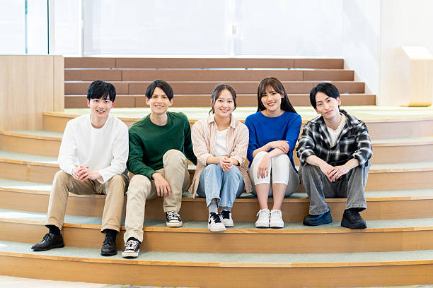 Male and female university students relaxing on campus