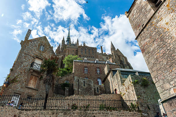 Mont Saint-Michel, France - August 28, 2021. Wide angle view showing tourists walking around Mont Saint-Michel in France.