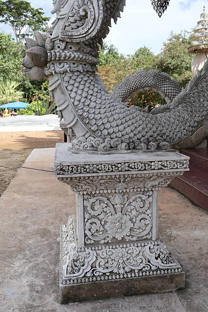 istock An elaborate stone carving on display outdoors. The sculpture has intricate designs and is adorned with what appears to be a dragon motif 2240536132