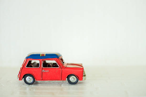istock Model red retro toy car on white wall background, Miniature toy car 2240537145
