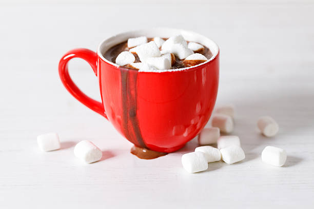 istock Hot chocolate in red cup on white wooden table background. 2240538410