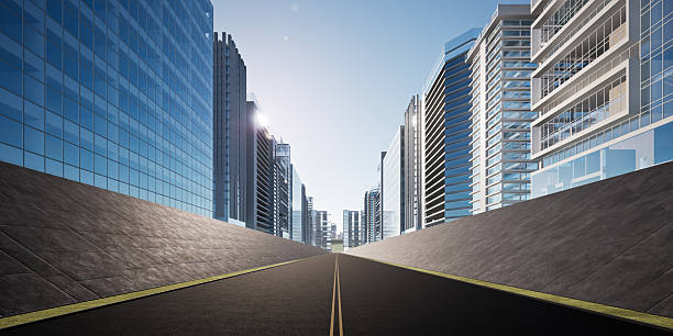 3D rendering of asphalt road in perspective view with high-rise buildings in background. Modern city infrastructure and urban growth for commercial backgrounds i.e. automotive, financial, corporate.