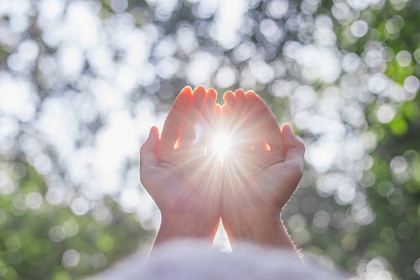 istock Human hands respect and pray on nature bokeh background 2240542611