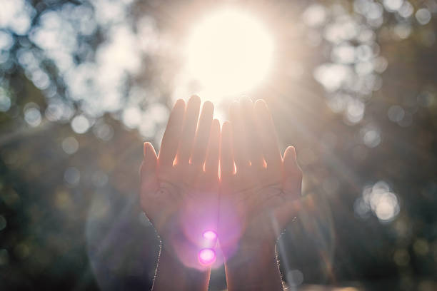 istock Human hands respect and pray on nature bokeh background 2240542612