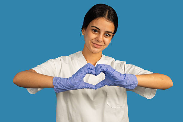 istock Healthcare worker wearing gloves making heart shape 2240543618