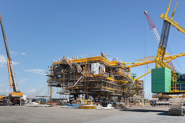 istock Oil rig in construction site against clear sky, towering structure frame, scaffolding system of mechanical and electrical installed. Represent industrial progress, construction technology engineering. 2240544059