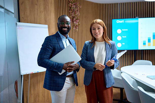 istock Diverse business professionals smiling in modern office meeting room 2240545009