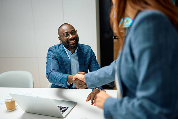 istock Business people shaking hands confirming a successful deal 2240545028