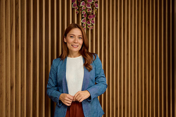 istock Confident businesswoman smiling standing in modern office 2240545144