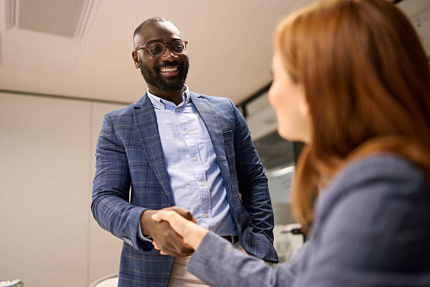 istock Diverse business professionals shaking hands in office meeting 2240545198