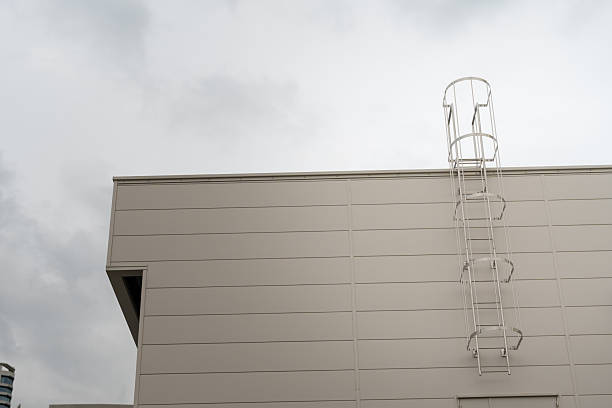 istock Climbing ladder at building exterior. 2240545326