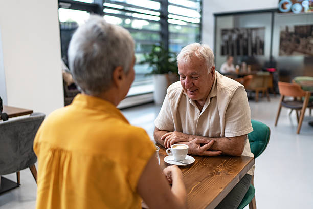 istock Senior couple enjoying conversation over coffee in cafe 2240546685