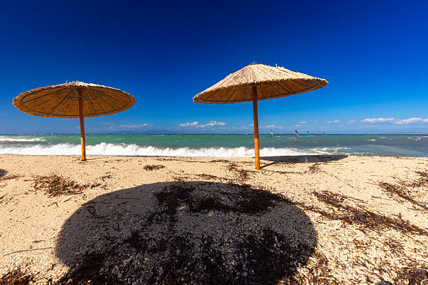 Sunny Beach Day with Windsurfer and Straw Umbrella, Lefkada, Greek Island