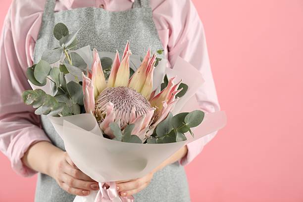 istock Florist with beautiful bouquet on pink background, closeup 2240547682