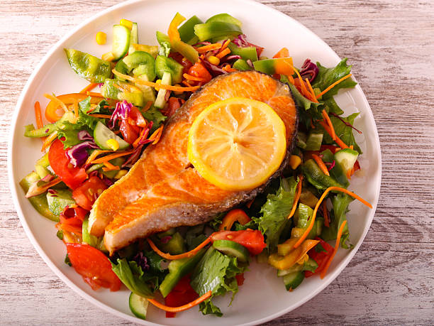 istock salmon with salad on plate 2240548046