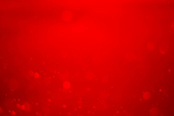 Golden blurred bokeh lights on red background. Glitter sparkle stars for celebrate. Overlay for your design