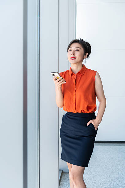 istock Businesswoman using smart phone near the window 2240552805
