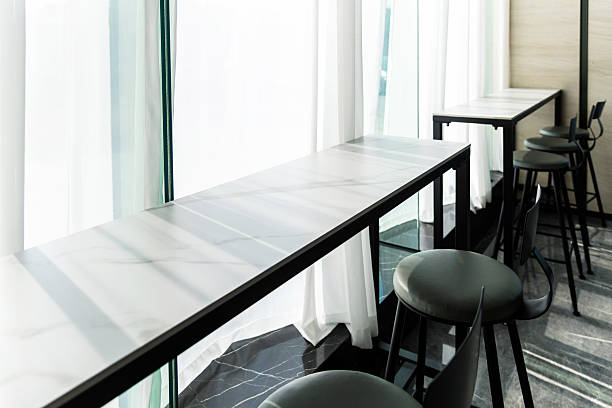 istock Rows of modern chairs lined up and table near window 2240553005