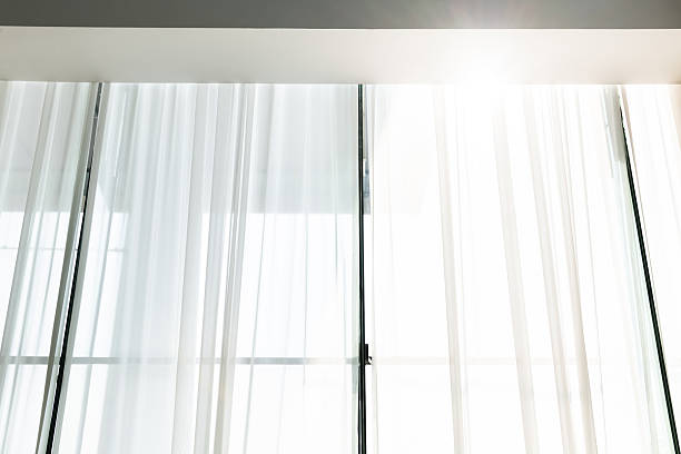 Low angle view of white curtain hanging from the ceiling