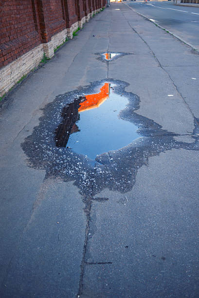 istock puddle at the street 2240555335