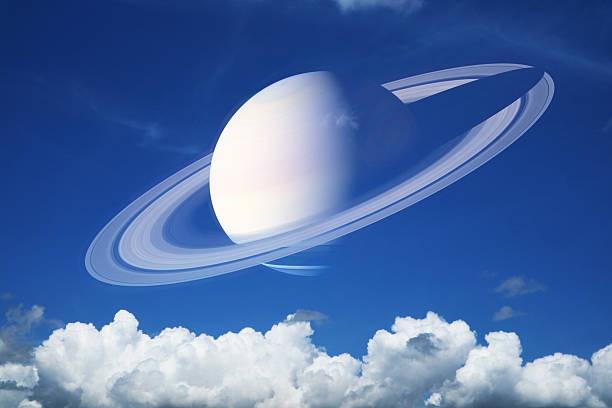 istock Saturn near earth and pure clear blue sky huge white gray cloud and sunlight 2240564800