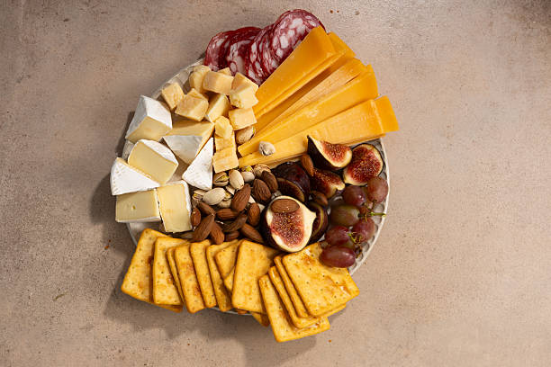istock Top view of cheese platter with cheddar and other figs nuts 2240567112