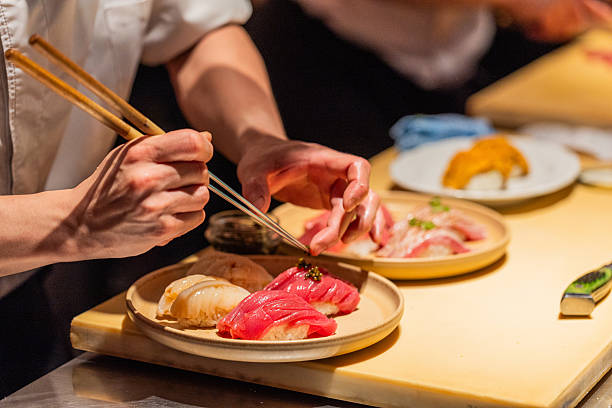 istock Sushi chef preparing colorful sushi platter with precision and care 2240570562