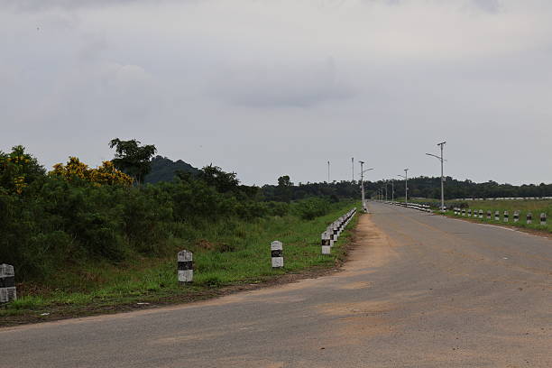 istock Open road scene, tranquil and empty highway bordered by lush greenery, ideal for road trip themes and travel narratives. 2240571464