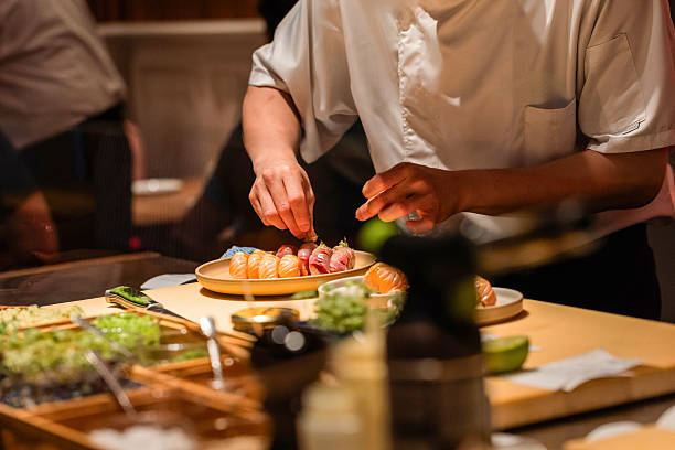 istock Sushi chef preparing fresh sushi rolls with vibrant ingredients on display 2240572124