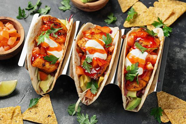 istock Mexican Fish Tacos with fresh vegetables, sour cream and chilli sauce 2240572219