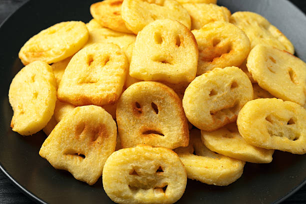 Fried Halloween potato shapes on black plate