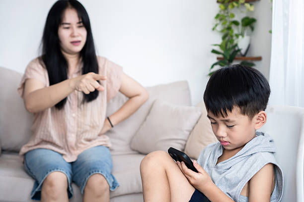 istock Asian boy addicted to playing games on his smartphone 2240575317