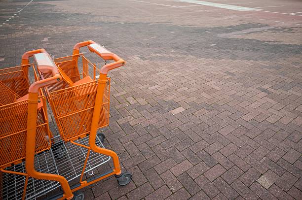 istock Orange shopping carts in empty outdoor parking lot 2240575404