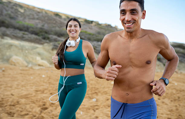 istock Couple running at the beach 2240577666