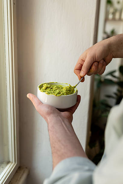 istock Hands mixing guacamole in a bowl with natural light (Raw Food) 2240578222