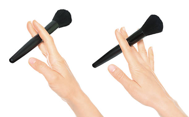istock Set of hands holding cosmetic brushes isolated on transparent background 2240578340