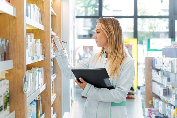 istock Female Apothecary Using Clipboard in Pharmacy 2240584052