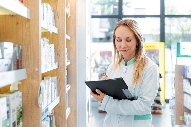 istock Pharmacist Preparing Prescription Notes on Clipboard 2240584070