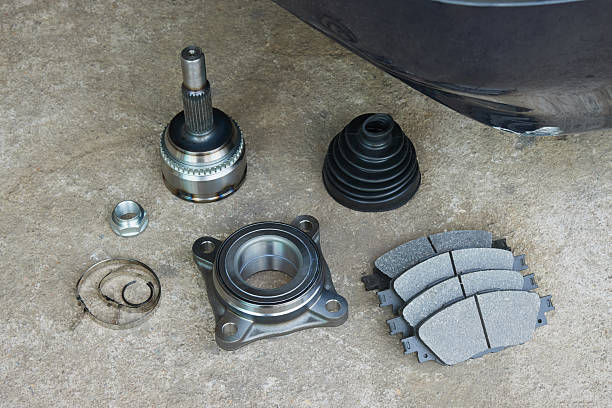 Mechanical Engineering or Industry Concept by Ball Bearing and Auto Part Such as CV Joint Drive Shaft, Drive Shaft Rubber Boot, Brake Pad and Nut
