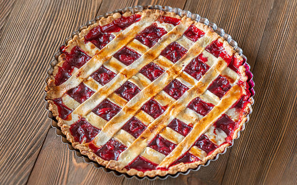 istock Freshly baked lattice-top cherry pie resting beautifully on rustic wooden surface 2240592305