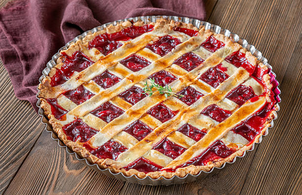 istock Freshly baked lattice-top cherry pie resting beautifully on rustic wooden surface 2240592332