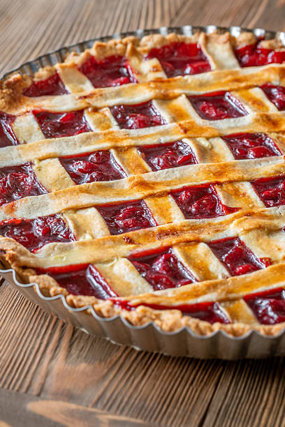 istock Freshly baked lattice-top cherry pie resting beautifully on rustic wooden surface 2240592637