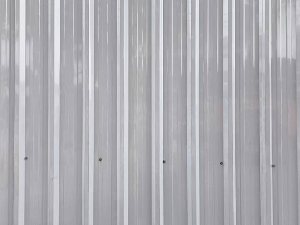 Old metal rolling shutter door. Industrial steel texture shows aging. For backgrounds, architectural design elements, and industrial or vintage themed projects