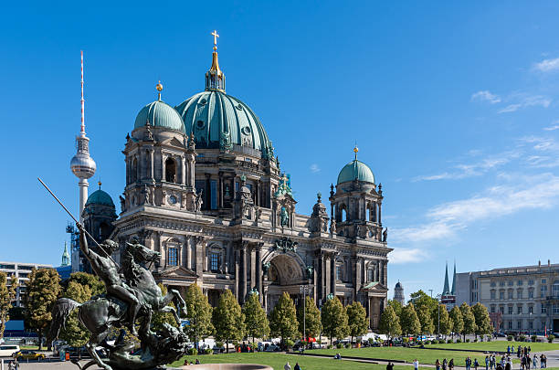 Germany, Berlin, Lustgarten, Berlin Cathedral, September 24, 2025 - The Berlin Cathedral with the TV Tower with tourist on the meadow