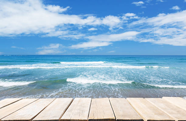 empty wooden table and Sea landscape of sandy beach. Summer time