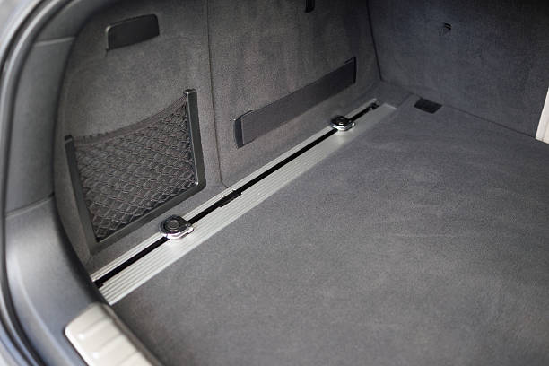 istock Clean car trunk interior with grey carpet and storage net compartment 2240600170