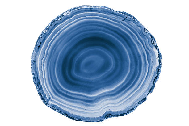 A detailed macro photograph of a vivid blue geode, showcasing intricate crystal formations and contrasting layers of natural marble patterns, highlighting the elegance and beauty of geological formations.