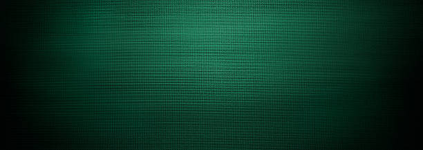 istock Dark emerald and forest green textile with subtle woven texture and soft vignette edges. The horizontal panoramic format enhances depth, creating a sophisticated backdrop with rich tonal gradient 2240607153