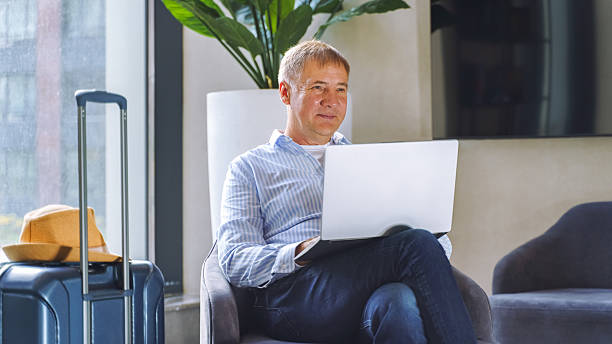 istock Relaxing at a travel lounge while working on a laptop during a leisure trip 2240610825