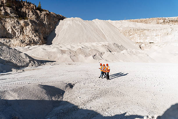 istock Group of workers wearing helmets planning at quarry, copy space 2240612295